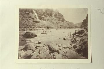Photo from Edwards Collection captioned, "When we tried to get the wrecked boat." Kane and McDonald are on the rock and the boat is pinned against it. The accident occurred in 1891 on the Best Expedition